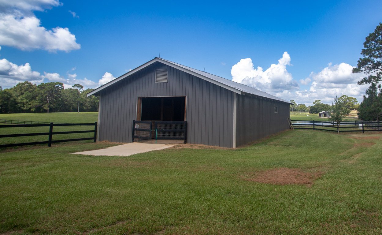 The private barn set against board fencing
